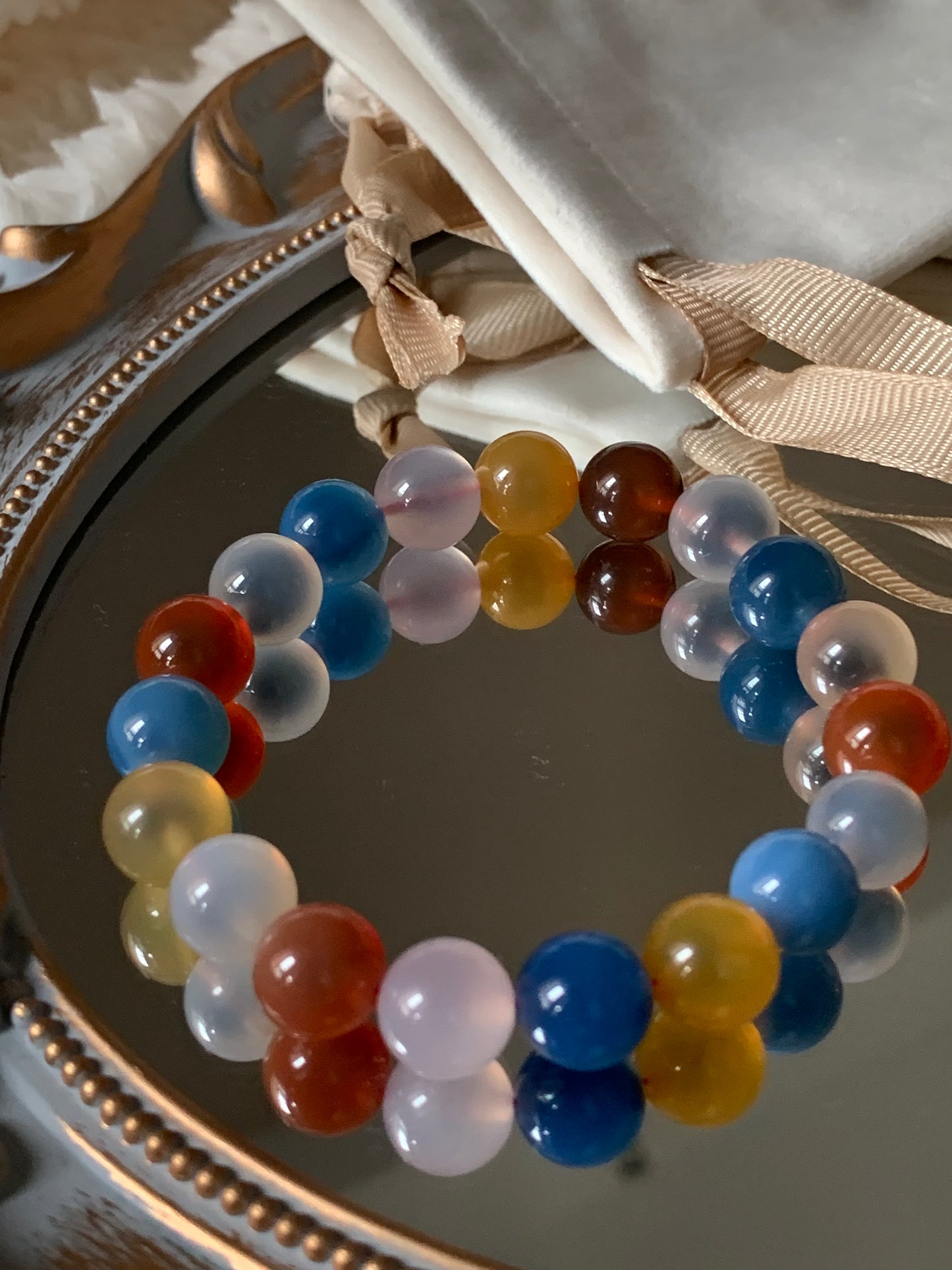 Close-up of the 'Univese By My Side' Natural Sugar Agate Bracelet showcasing its vibrant colors and unique stone patterns.