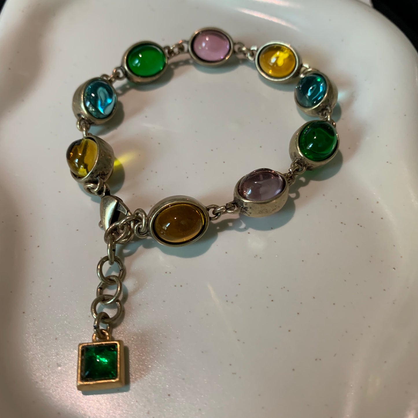 Close-up of the rainbow friendship bracelet with various gemstones