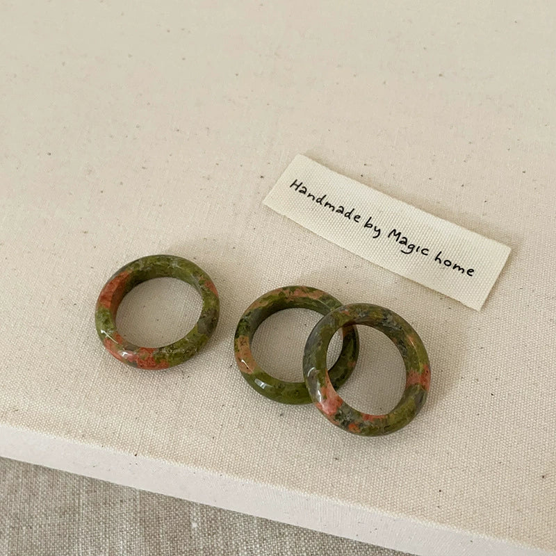 Floral Green Stone Ring: A delicate ring featuring a floral design with vibrant green stone.